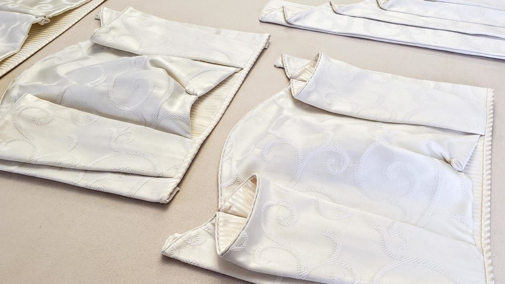 Narrow BEV'S BLOUSE Hidden Rod Pocket valances laying on workroom table before being shipped